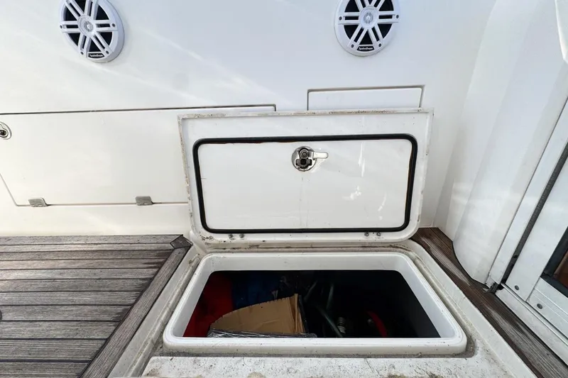 Slide: The Image of Open storage compartment on 2004 Sunseeker Sportfisher 37 boat deck. - 84