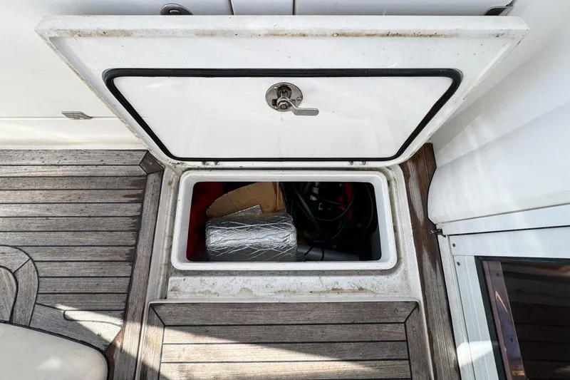 Slide: The Image of Open storage compartment on 2004 Sunseeker Sportfisher 37 boat deck. - 85