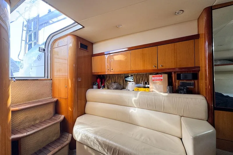 Slide: The Image of Interior of 2004 Sunseeker Sportfisher 37 yacht with leather seating and wooden cabinetry. - 90