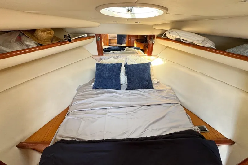 Slide: The Image of Luxurious cabin interior of 2004 Sunseeker Sportfisher 37 with cozy bedding and skylight. - 91