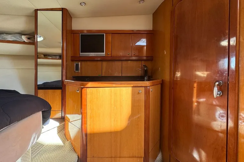 Slide: The Image of Interior of 2004 Sunseeker Sportfisher 37 yacht with wood cabinetry and compact kitchenette. - 99