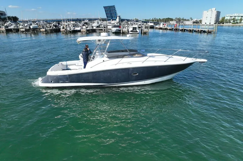 Slide: The Image of 2004 Sunseeker Sportfisher 37 yacht cruising in a marina, clear blue water. - 5