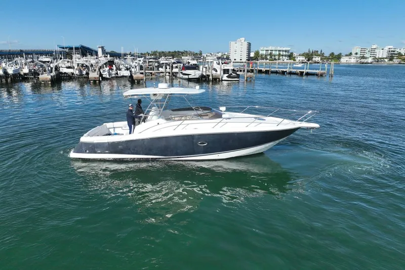 Slide: The Image of 2004 Sunseeker Sportfisher 37 yacht cruising in a marina under clear blue skies. - 4