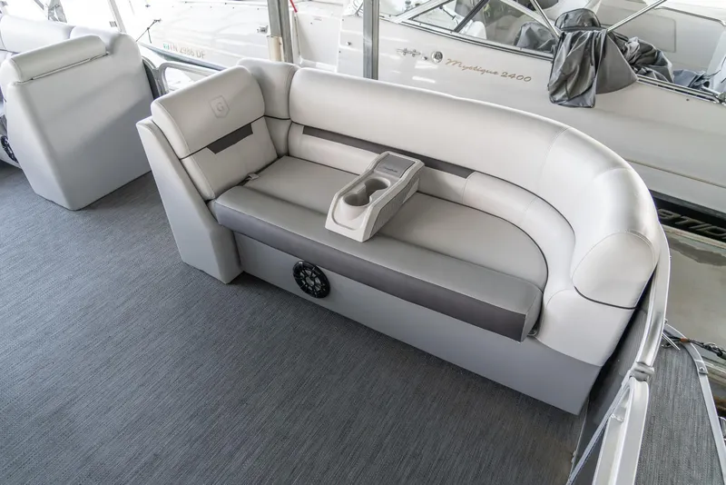 Slide: The Image of 2023 Godfrey Sweetwater 2186 C boat interior with gray seating and cup holders. - 10