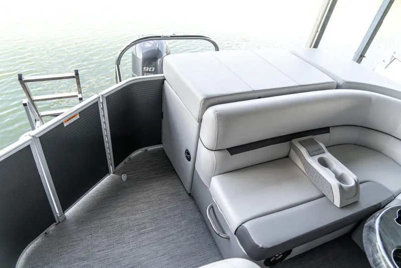 Slide: The Image of 2023 Godfrey Sweetwater 2186 C pontoon boat interior with seating and motor view. - 15