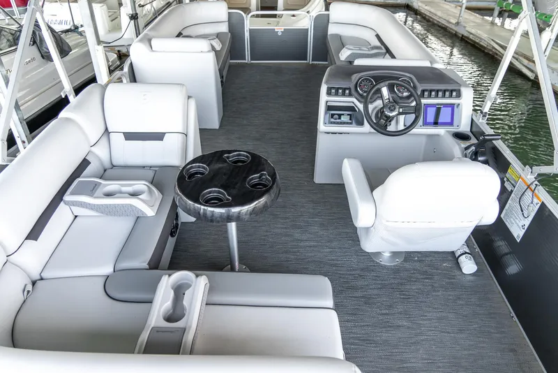 Slide: The Image of 2023 Godfrey Sweetwater 2186 C pontoon boat interior with plush seating and modern helm. - 17