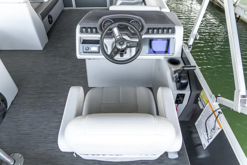 Slide: The Image of 2023 Godfrey Sweetwater 2186 C boat helm with modern controls and comfortable seating. - 19