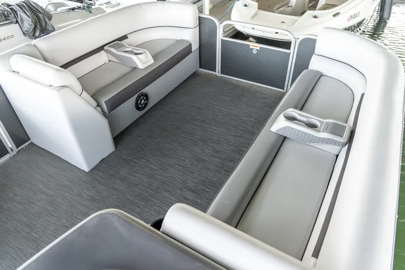 Slide: The Image of 2023 Godfrey Sweetwater 2186 C pontoon boat interior with gray seating and carpet. - 21