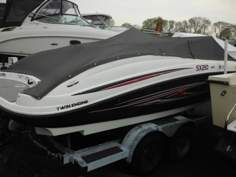 Slide: The Image of 2008 Yamaha Boats SX210 on trailer, covered, with twin engine design. - 13
