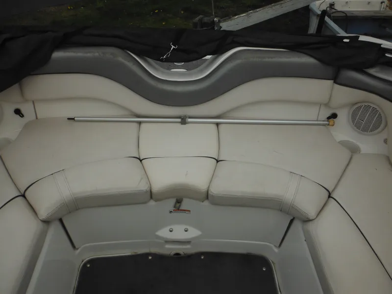 Slide: The Image of 2008 Yamaha Boats SX210 interior seating with white upholstery and speaker. - 22