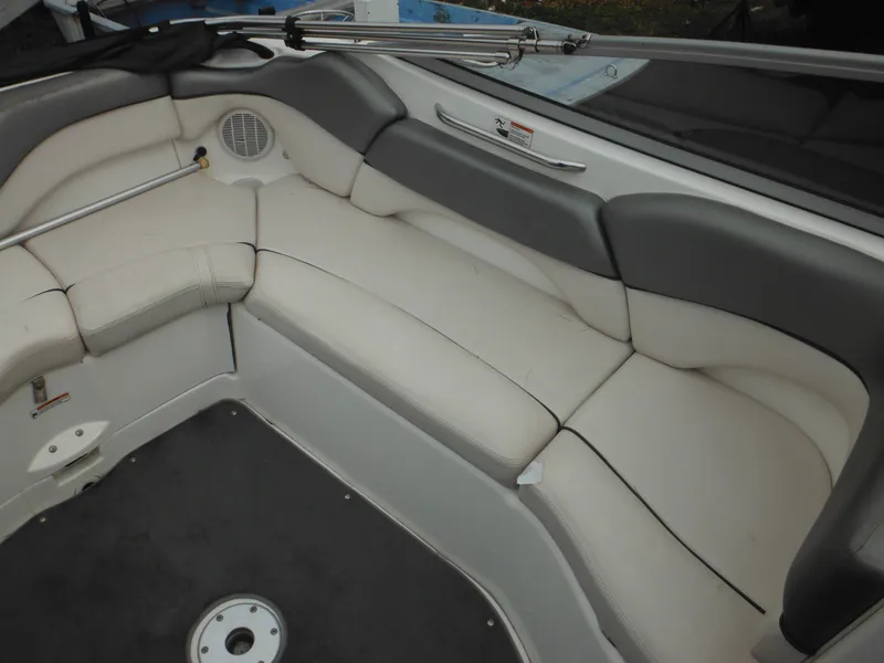 Slide: The Image of 2008 Yamaha Boats SX210 interior seating with gray and white upholstery. - 23