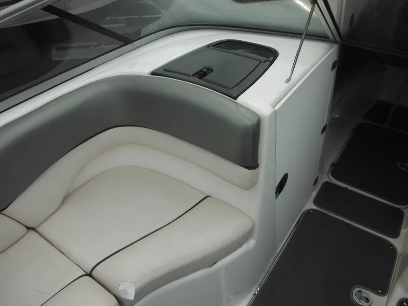 Slide: The Image of 2008 Yamaha SX210 boat interior with gray and white seating and storage compartment. - 24
