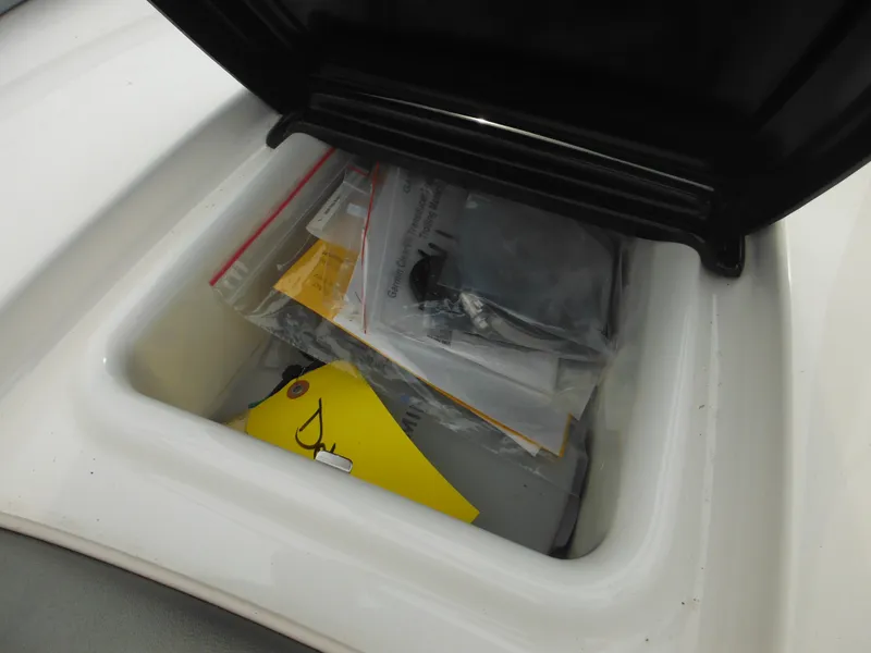 Slide: The Image of Storage compartment of 2008 Yamaha SX210 boat with various items inside. - 25