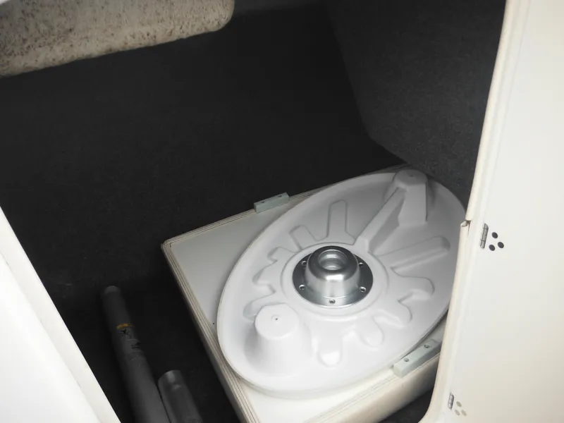 Slide: The Image of 2008 Yamaha SX210 boat storage compartment with white cover and pipes. - 26