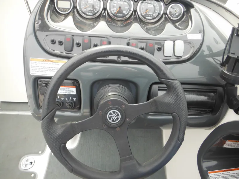 Slide: The Image of Steering wheel and dashboard of 2008 Yamaha Boats SX210, featuring gauges and controls. - 30
