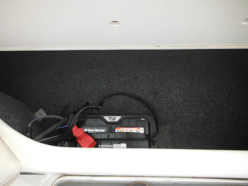 Slide: The Image of Battery compartment of 2008 Yamaha Boats SX210, featuring a West Marine battery. - 31