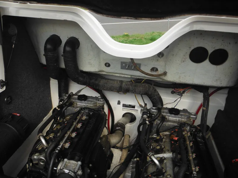 Slide: The Image of Engine compartment of a 2008 Yamaha Boats SX210, showcasing dual engines and ventilation hoses. - 36