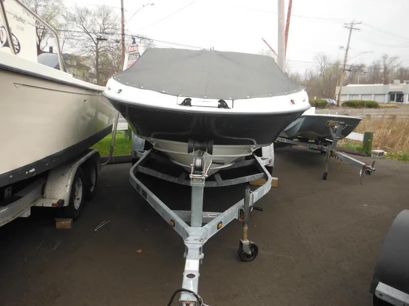 Slide: The Image of 2008 Yamaha SX210 boat on trailer, covered and parked outdoors. - 5