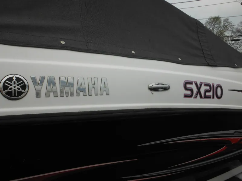 Slide: The Image of 2008 Yamaha Boats SX210 with cover, showcasing brand and model logos. - 8