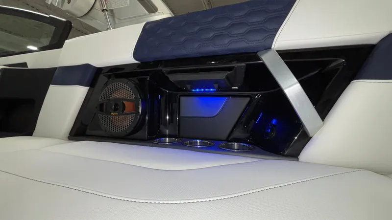 Slide: The Image of 2025 MasterCraft XT23 interior with speaker, cup holders, and blue LED lighting. - 10