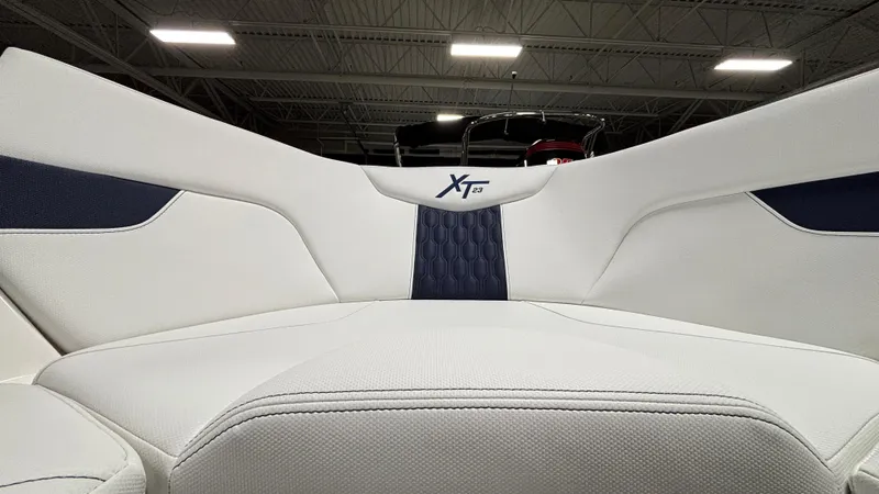 Slide: The Image of 2025 MasterCraft XT23 boat interior with white and navy upholstery, showcasing modern design. - 16
