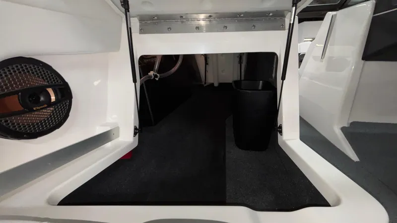 Slide: The Image of 2025 MasterCraft XT23 interior storage compartment with speaker and clean design. - 21