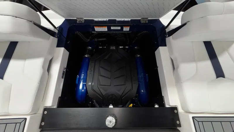Slide: The Image of 2025 MasterCraft XT23 engine compartment with sleek design and blue accents. - 26
