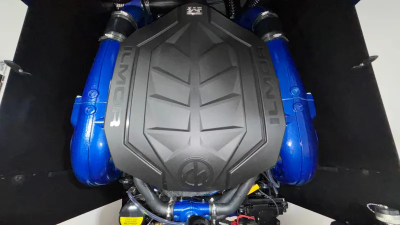 Slide: The Image of 2025 MasterCraft XT23 engine with blue components and black cover. - 27