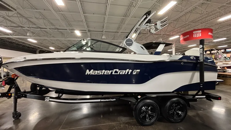 Slide: The Image of 2025 MasterCraft XT23 boat displayed indoors on a trailer. - 3