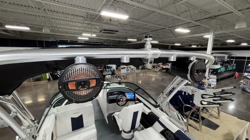 Slide: The Image of 2025 MasterCraft XT23 boat interior with advanced audio system in showroom. - 31