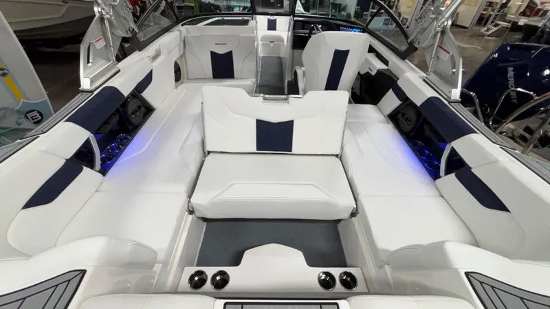Slide: The Image of 2025 MasterCraft XT23 boat interior with white and navy seating, featuring modern design and ambient lighting. - 32
