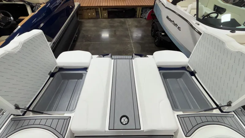 Slide: The Image of 2025 MasterCraft XT23 boat interior with open storage compartments. - 34