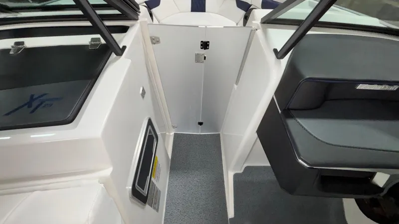 Slide: The Image of 2025 MasterCraft XT23 boat interior with sleek seating and modern design. - 38