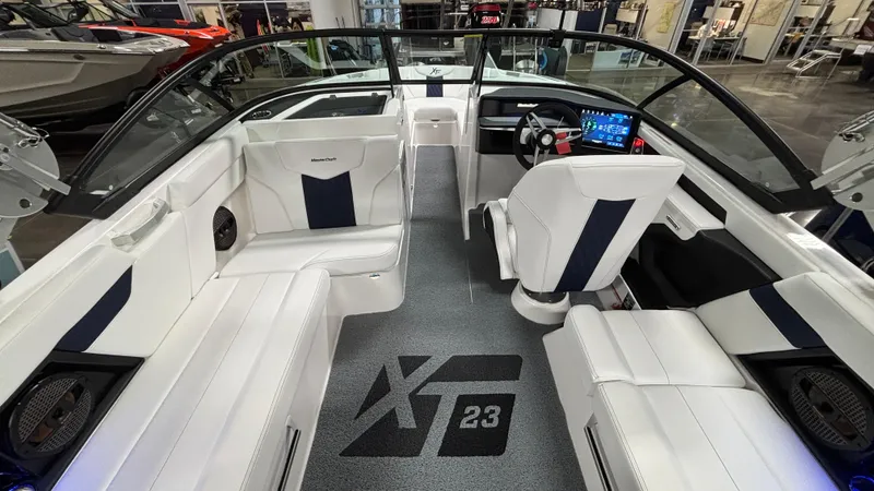 Slide: The Image of 2025 MasterCraft XT23 boat interior with white seating and modern dashboard. - 4