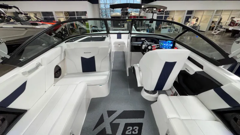 Slide: The Image of 2025 MasterCraft XT23 boat interior with modern seating and dashboard, showcasing luxury design. - 5