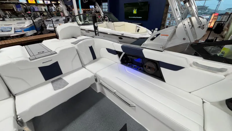 Slide: The Image of 2025 MasterCraft XT23 boat interior with white seating and modern dashboard. - 7
