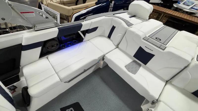 Slide: The Image of 2025 MasterCraft XT23 boat interior with white and navy seating, modern design, and premium features. - 9
