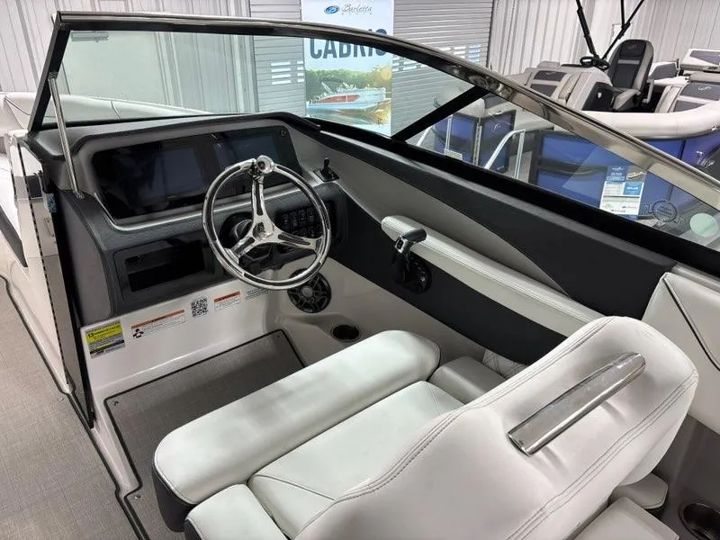 Slide: The Image of Interior of a 2026 Regal LX4 boat, featuring a sleek steering wheel and modern dashboard. - 12