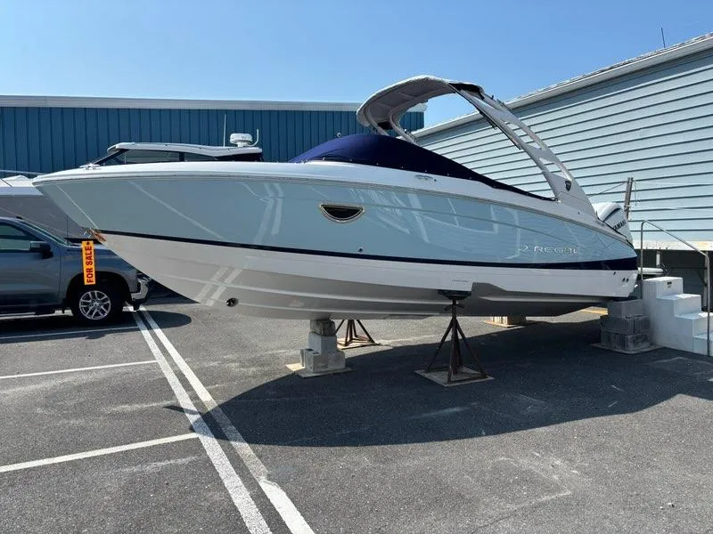 Slide: The Image of 2026 Regal LX4 boat on display, elevated on stands, with a "For Sale" sign. - 3