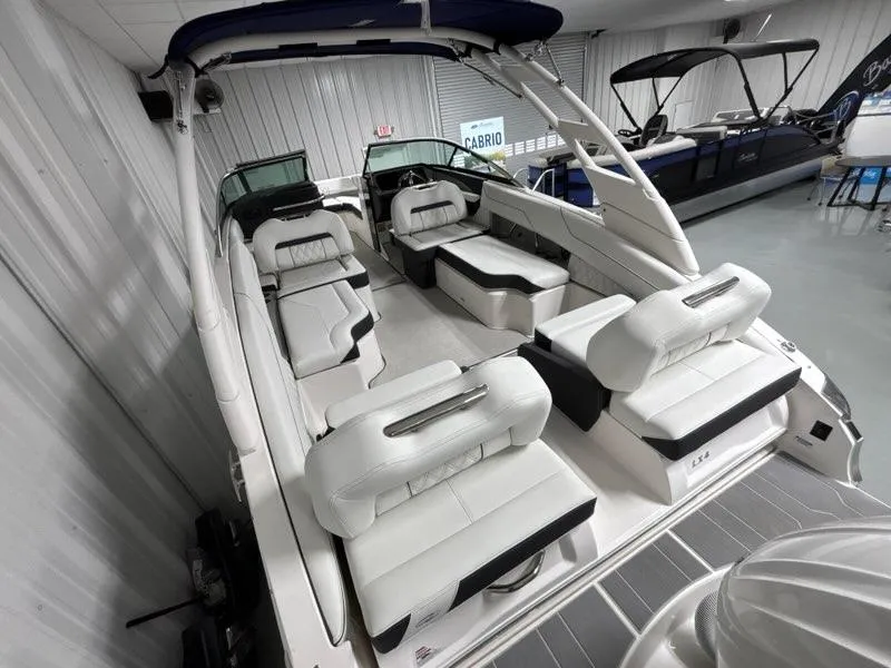 Slide: The Image of 2026 Regal LX4 boat interior with luxurious white seating and modern design. - 6