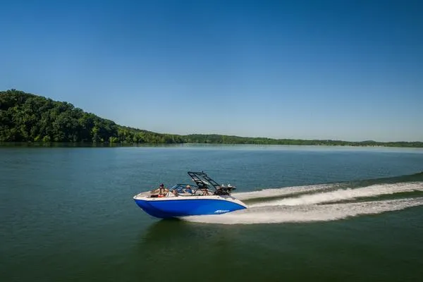 Slide: The Image of 2025 Yamaha AR250 boat cruising on a serene lake under a clear blue sky. - 10