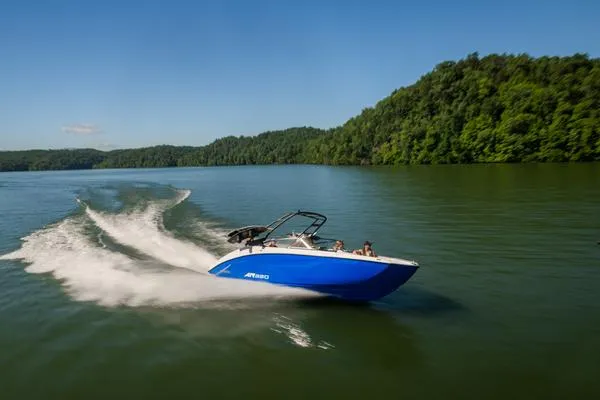 Slide: The Image of 2025 Yamaha AR250 boat cruising on a lake with lush green hills in the background. - 2