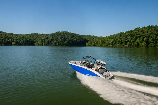 Slide: The Image of 2025 Yamaha Boats AR250 speeding on a serene lake surrounded by lush greenery. - 3