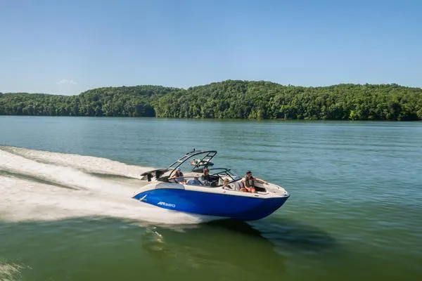 Slide: The Image of 2025 Yamaha AR250 boat cruising on a lake with lush green hills in the background. - 5