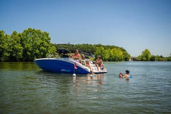 Slide: The Image of 2025 Yamaha AR250 boat on a lake with people enjoying the water. - 6