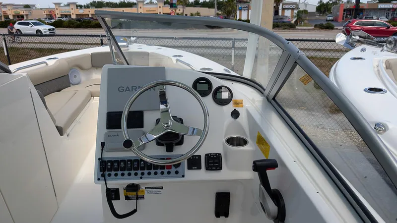 Slide: The Image of 2025 Key West 239 DFS boat dashboard with steering wheel and controls. - 11