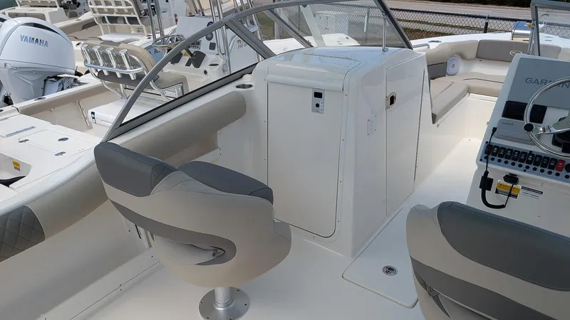 Slide: The Image of 2025 Key West 239 DFS boat interior with seating and control panel. - 12