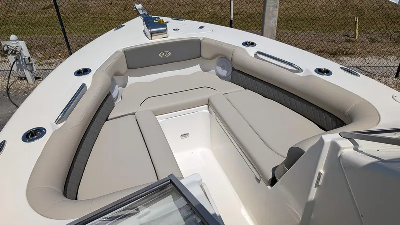 Slide: The Image of 2025 Key West 239 DFS boat interior with cushioned seating and storage compartments. - 14