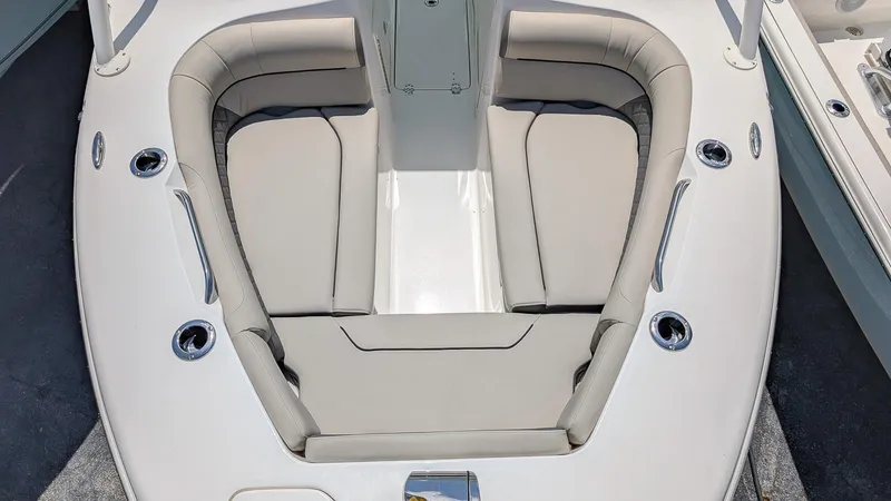 Slide: The Image of 2025 Key West 239 DFS boat interior with cushioned seating and cup holders. - 15