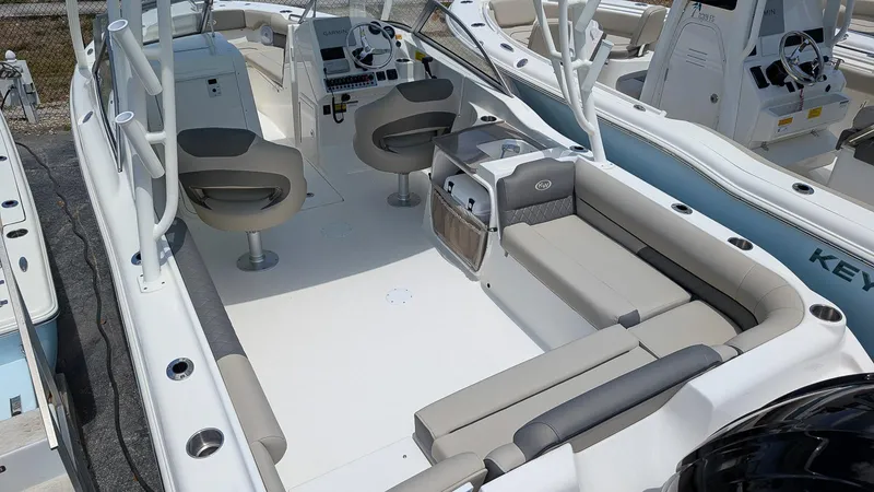 Slide: The Image of 2025 Key West 239 DFS boat interior with seating and helm, showcasing modern design. - 3